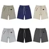 Lâche Hommes Shorts Couleur Unie Pantalon De Survêtement Couples Occasionnels Pantalons De Jogging High Street Shorts Homme triangle métal Court Femmes Hip Hop S1787