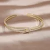 Bangle 14k Real Gold Plating Exquisite AAA Luxury Full Zircon Knot Armband Elegant Womens Wedding Party Opening Justerbar 231027