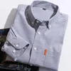 Polo da uomo 2023 Bello Oxford Spinning Camicia a maniche lunghe Colletto con bottoni Tinta unita Business Casual Top Cardigan Versatile