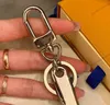 Luxurys Yüksek kaliteli şişe açıcı anahtar zincirleri severler anahtarlık metal anahtar yüzüğü gümüş erkek kadın kadın çanta çanta kolye aksesuarları9490959