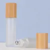 Cam şişe üzerinde parfüm rulo 5ml 10ml Metal top silindir bambu kapak esansiyel yağ şişeleri ile buzlu