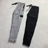 Varumärkesdesigners Pants Stone Metal Nylon Pocket broderade Badge Casual byxor Thin Reflective Island Pants 136 423
