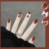 偽の爪偽のグラデーションオレンジレッド24pcs/set bow指先のアート付きラウンドミッドレングスファッションアーモンドシェイプ