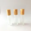 Flacons à roulettes en verre transparent givré de 5 ml, 10 ml, contenants avec boule à roulettes en métal et capuchon en plastique à grain de bois pour parfum d'huile essentielle