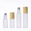 Flacons à roulettes en verre transparent givré de 5 ml, 10 ml, contenants avec boule à roulettes en métal et capuchon en plastique à grain de bois pour parfum d'huile essentielle