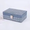 ジュエリーポーチ100PCポータブルレディースPUメイクアップボックス高品質のロックダストプルーフストレージイヤリングブレスレットネックレスボックス卸売