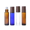 Flacon de massage en verre bleu marron clair, rouleau en acier, couvercle en faux bois noir, emballage cosmétique, récipient rechargeable, flacons vides d'huile essentielle de crème pour les yeux de 10 ml