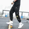 Pantalons pour hommes Poches latérales Cargo Harem Rubans Noir Hip Hop Casual Mâle Joggers Pantalon Mode Streetwear 220827