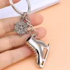 Metall Schlittschuhschuhe Schlüsselanhänger Winter Sport Schneeflocke Charm Schlüsselanhänger Halter Tasche Behänge Modeschmuck