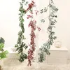 装飾的な花人工ブドウのラタンフェイクプラントウェディングガーデンのための花輪の壁の装飾