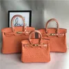 Diseñador de bolsos de platino Ostrich Bolsa de patrón de moda Portable Un hombro que inclina a la piel de vaca de cuero genuino de color naranja para mujeres