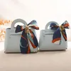 Confezione regalo 1pc Scatola di caramelle per matrimoni Confezione in pelle creativa a forma di borsa con farfallino per borsa per feste di compleanno