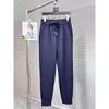 Pantalones de primavera elastics dise￱ador de lujo para hombres y huellas de mujeres pisos pellizcados icono peque￱o pantalones de cintura azul marino