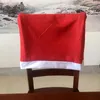 椅子はクリスマスの日の装飾赤い非織りのバックカバーサンタハットダイニングテーブル