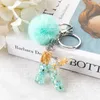 Клавки 1pc Keyring Blue Stone Gold Color Английский буква буквы с Pompom 26 слов от A до z очамы сумочки для женщины