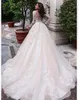 Abiti da sposa a linea Girocollo trasparente Sexy Bottone trasparente sul retro Maniche lunghe Applicazioni plus size Abito da sposa in pizzo vintage Vestios De Novia