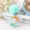 Клавки 1pc Keyring Blue Stone Gold Color Английский буква буквы с Pompom 26 слов от A до z очамы сумочки для женщины