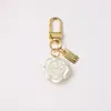 Rose fleur porte-clés lumière luxe décoratif polyvalent arc porte-clés perle gland sac pendentif