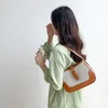 Bolsos de diseñador de lujo Nuevo nicho de mujer Bolso de hombro de lona ins empalme de moda mano arco triunfal axila sensación avanzada Ventas directas de fábrica