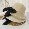 Berets printemps et d'été femelle Suncreen Sun Hat Children Bowknot Straw Pearl Beach Traw Parent-Child