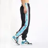 Pantalons pour hommes Pantalons à boutonnage pour hommes Tendance ample à jambes larges Boutons latéraux décontractés Pieds de poutre Basket-ball Entraînement Pantalons de survêtement Joggers