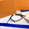 Fascino Bracciali di lusso Lettera classica Plaid Corda in pelle Fibbia in oro argento Perline Corda a mano Bracciale coppia uomo e donna Moda retrò Gioielli regalo per feste