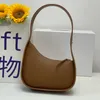 A linha line macia nova bolsa lua de meio couro feminino designer plano tira plana tira curva fechamento de zíper embreagem