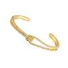 Bangle breed voor vrouwen goud geknoopte manchet luxe designer accessoire hard armbanden kerstcadeau vrouwelijk koper elegante bruiloft cadeaus