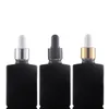 Flacon compte-gouttes en verre carré en gros 30 ml contenant d'huile essentielle givré noir clair avec bouchon noir argent doré