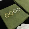 Boucles d'oreilles vintage en argent doré brillant avec lettres imbriquées