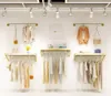 Estante de exhibici￳n montada en la pared Muebles comerciales de la tienda de ropa de ropa en la tienda de telas para mujeres Mostrar estante de tela para ni￱os