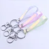 Keychains Lanyards telefonhandledsband Keyring Glansig ljus l￤dersladd h￤ngande sp￤nne laser mjukt lim lanyard doll h￤nge hand dh1kv