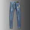 Vår sommar märkes jeans herr elastisk koreansk version slim fit fötter Golden Horse tryckta blå byxor