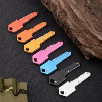 7 Farben Mini Klappmesser Schlüsselbund Outdoor Gadgets Schlüsselform-Taschenfruchtmesser Multifunktionales Werkzeugschlüsselkette Säbel Schweizer Selbstverteidigung Schlüsselbund