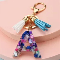 Keychains Fashion Harts Purple Stone Filling Letter Pendant Keychain med tofsar Simple Women 26 Initials Car Key Ring Charm Decoration
