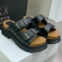 QUAKE STRAP SANDAL makes its mark with the brands couture wood and black rubber hybrid sole this shoe will bring a stylish touch to any look this season sandals