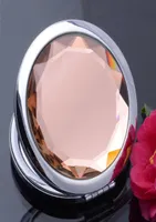 20 colores Mirror de cristal redondo Espejo de bolsillo de bolsillo de bolsillo compacto ILUMINADO MEJORES Mujeres de maquillaje Favores Accesorios de maquillaje 10pcs5201770