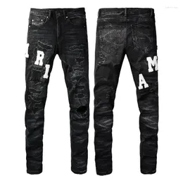 Jeans da uomo Toppa ricamata in pelle nera Pantaloni in denim skinny sottili elastici invecchiati strappati Moda Hip Hop