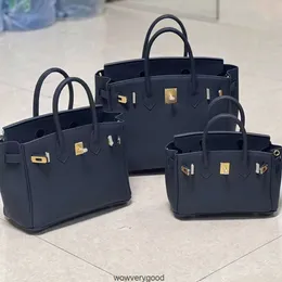 Tasarımcı çantaları lüks moda kılıfları gelişmiş hissediyorum çanta Togo Üst Kat Cowhide Lychee Tahıl Büyük kapasiteli ve şık bir omuzlu gerçek deri kadın çantası