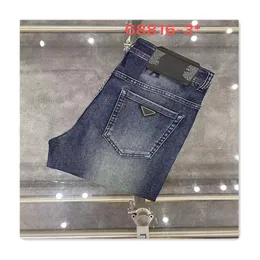 Luksusowe męskie designer dżinsy dżinsy szczupłe spodnie Wysokiej jakości trójkąt logo niebieskie dżinsy małe spodnie nóg zwykłe swobodne klasyczne sprężyste spodnie jesienne