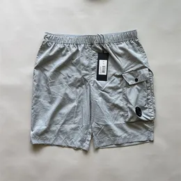 أوروبا مصمم رجال واحد عدسة جيب نايلون سراويل قصيرة غير رسمية تجفيف سريع CP شورت شورت شورت Sweatshorts الأولاد السباحة في الهواء الطلق.