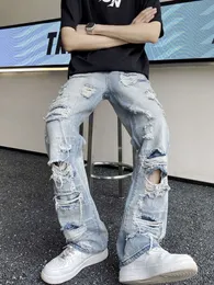 Ginocchia e jeans strappati in stile americano per uomo con un senso di design di pantaloni da mendicante casual hiphop di nicchia di High Street