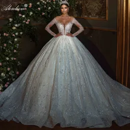 Prächtiges Illusions-Ballkleid-Hochzeitskleid mit U-Ausschnitt und vollen Ärmeln. Glitzernde Prinzessinnen-Brautkleider mit Blumendruck und Perlenstickerei aus Spitze