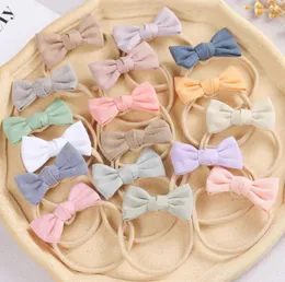 Akcesoria do włosów 24pcs/partia 2.75 "Solid Cotton Bows Baby Hairband Girls Fabric Bow Elastic Nylon Headband Kid Hahtie