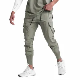 2023 nuovi pantaloni sportivi pantaloni casual stile sottile allentato velocità mazzi asciutti piede corsa formazione tuta elastica uomo J6KJ #