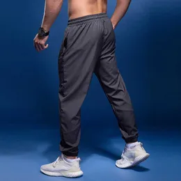 Calças masculinas Bintuoshi Novas calças esportivas Men correndo calças com zíper bolsões de treinamento Sports Sports Troushers Joggings Fitness Sweatpants Y240513