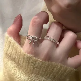 Дизайнерские кольца корейский жемчужный лук двойной эластичный кросс -кольцо женская пара кольца новое роскошное указательное указательное кольцо