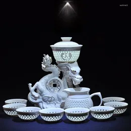 Teaware sätter kinesiska semi automatiska te -set dricker ihåliga honungskaka keramiska porslin glas draken örn lat silver kopp