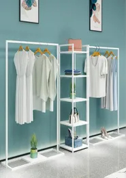 Simple clothing store display rack floor type men039s shop shelf women039s cloth hanging clothes racks white against the wal3234481