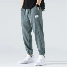 Pantaloni harem di seta di ghiaccio uomini estate sciolti sciolti di jogging comfort pantaloni elastici pantaloni di grandi dimensioni pantalon sarouel homme 240408